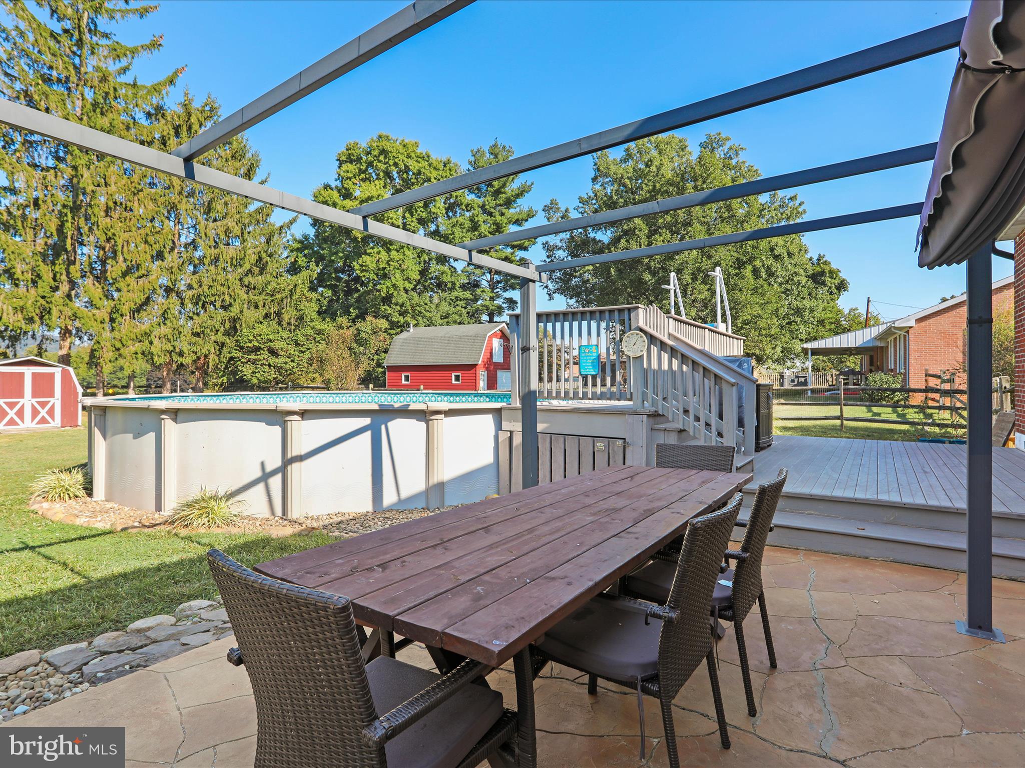 12530 Ashton Road Clear Spring, MD 21722 - Photo 40 of 57 a balcony with wooden floor table and chairs