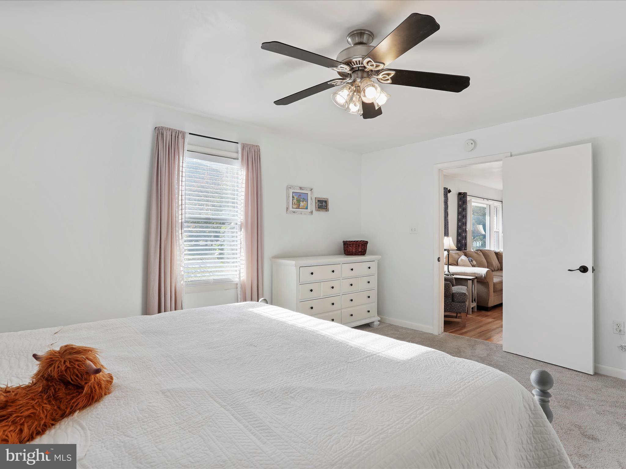 12530 Ashton Road Clear Spring, MD 21722 - Photo 9 of 57 a bedroom with a large bed and a chandelier