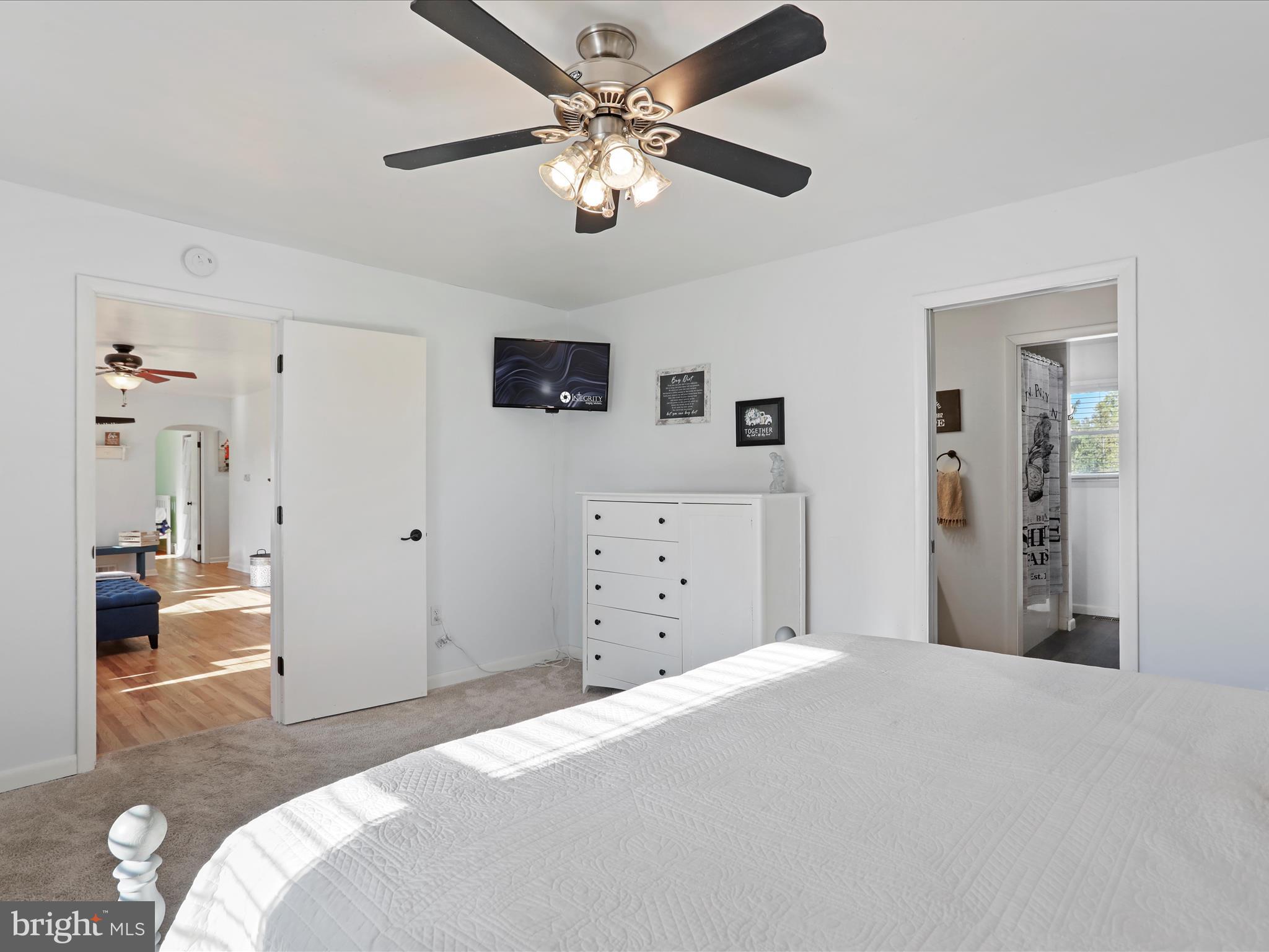 12530 Ashton Road Clear Spring, MD 21722 - Photo 10 of 57 a bedroom with a large bed and a chandelier