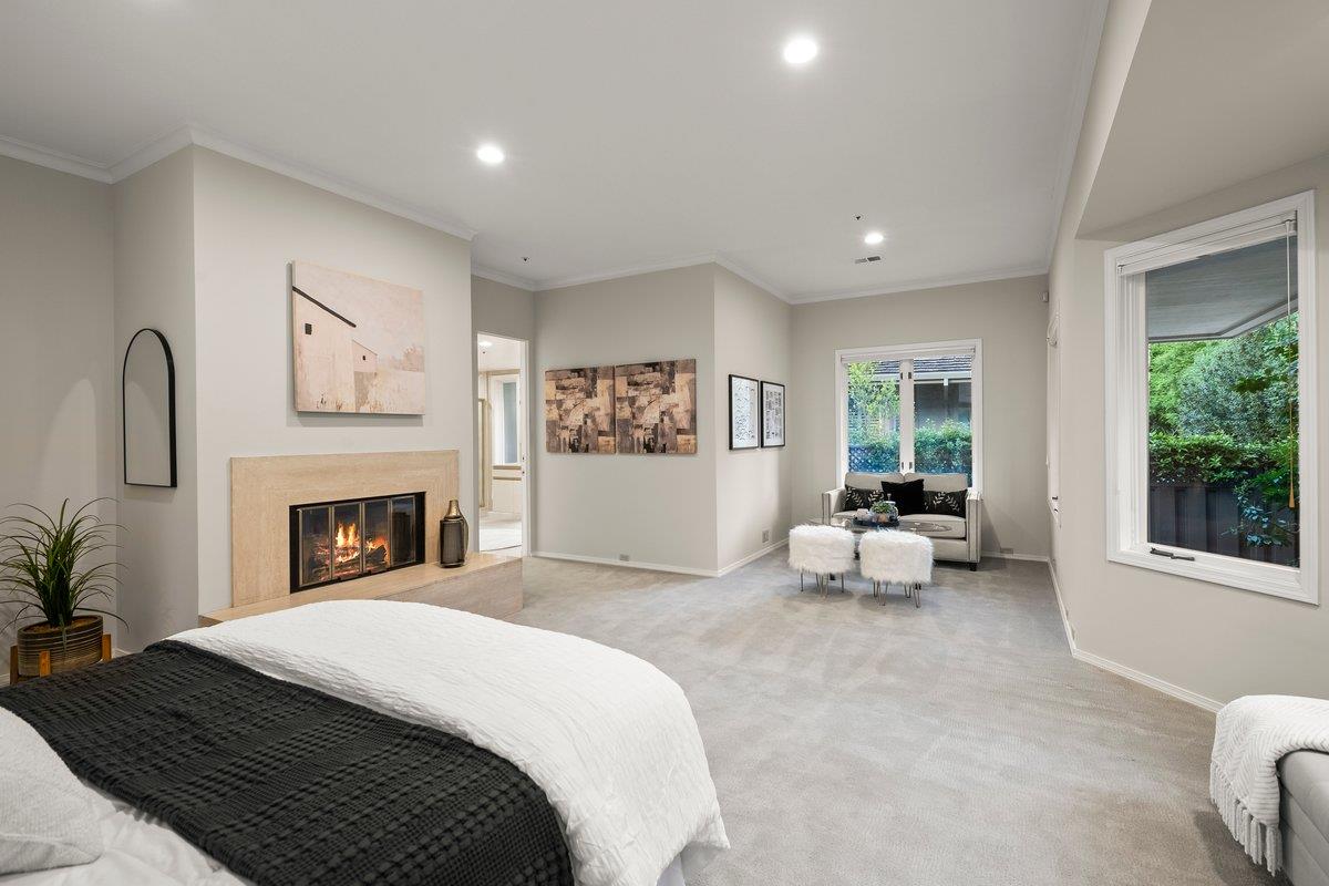 639 Morningside Road Los Altos, CA 94022 - Photo 23 of 42 a spacious bedroom with a large bed and a fireplace
