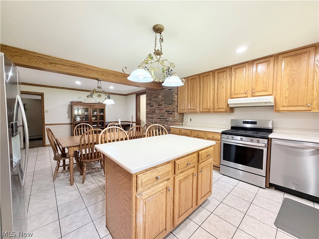 12590 Rockhaven Road Chesterland, OH 44026 - Photo 7 of 25 Kitchen featuring light wood cabinetry, white countertops, stainless steel appliances, and a central island