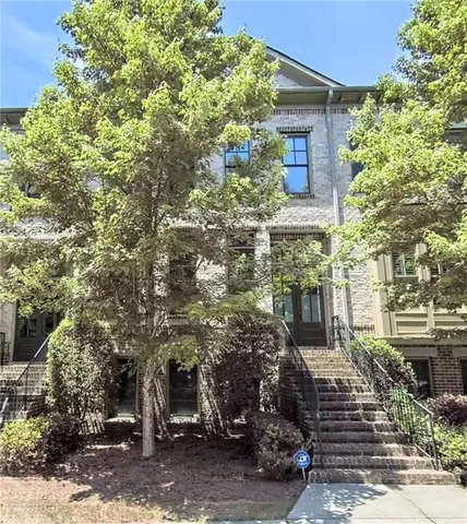 a front view of a house with trees