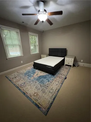 a bedroom with a bed and window