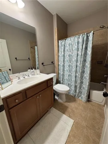 a bathroom with a double vanity sink toilet and shower