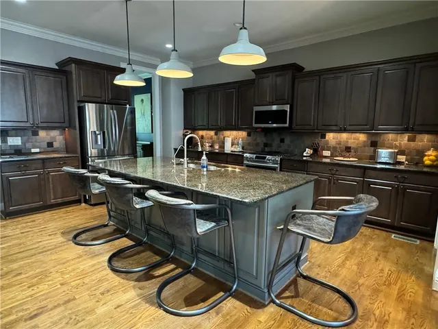 a kitchen with sink cabinets and appliances