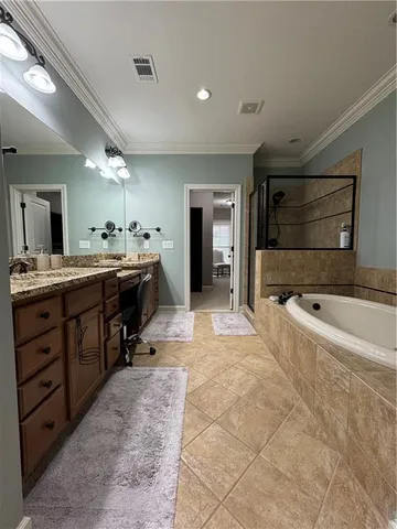 a large bathroom with a sink mirror and a bath tub