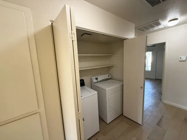 a view of storage and utility room with wooden floor