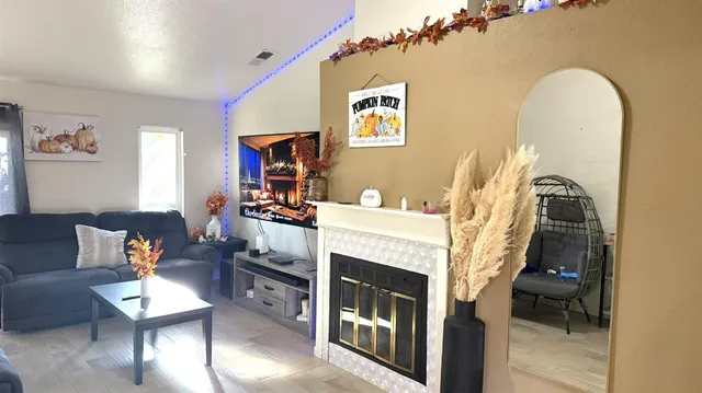 a living room with furniture and a fireplace