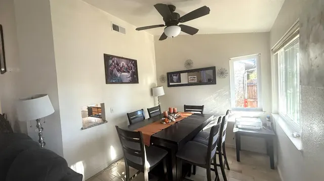 a view of a dining room with furniture and a window