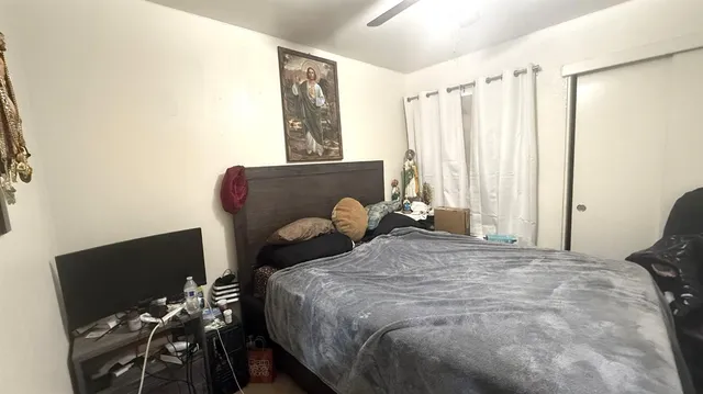 a bedroom with a bed and a flat tv screen