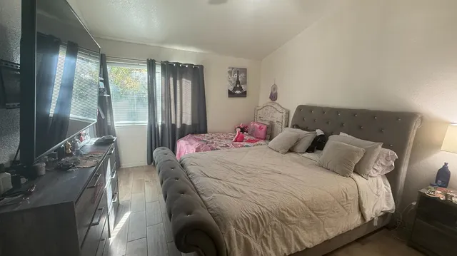a bedroom with a bed and glass door