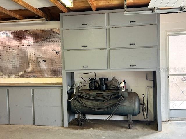 17403 Southwest 27 Ct Road Ocala, FL 34473 - Photo 24 of 47 a room with a refrigerator and a wooden cabinets