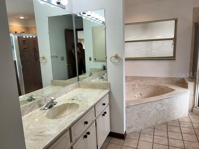 17403 Southwest 27 Ct Road Ocala, FL 34473 - Photo 31 of 47 a bathroom with a granite countertop sink and a mirror