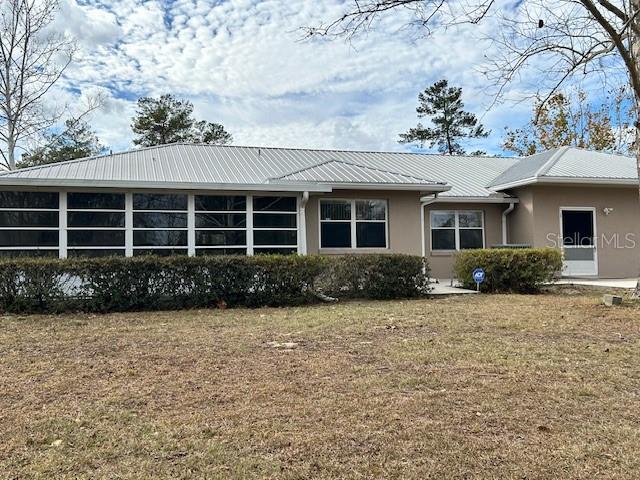 17403 Southwest 27 Ct Road Ocala, FL 34473 - Photo 9 of 47 a front view of a house with a garden