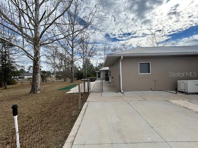 17403 Southwest 27 Ct Road Ocala, FL 34473 - Photo 10 of 47 a backyard of a house with large trees and outdoor seating