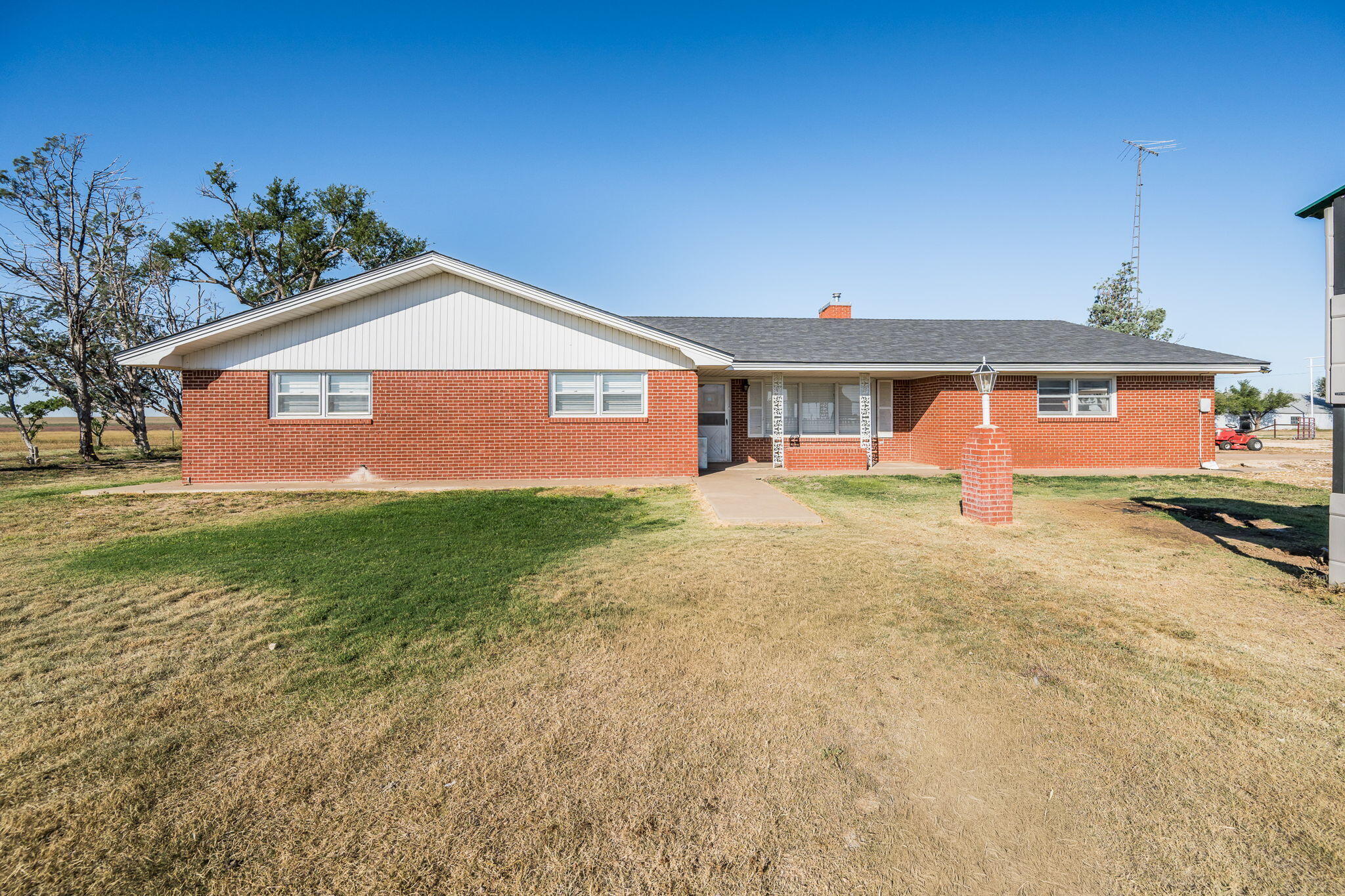 1723 County Road 9 Tulia, TX 79088 - Photo 1 of 32 a front view of a house with garden