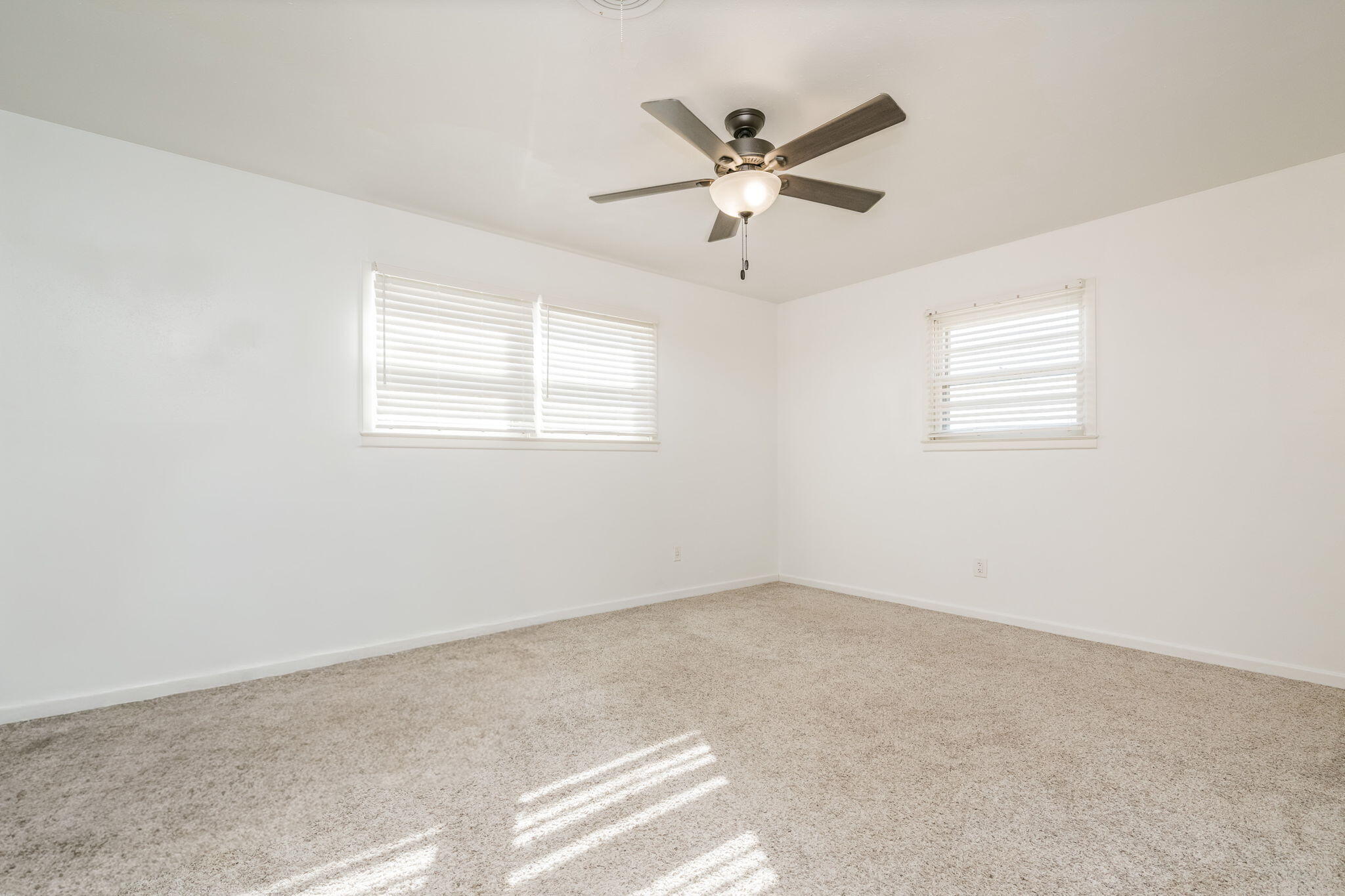1723 County Road 9 Tulia, TX 79088 - Photo 15 of 32 an empty room with windows and fan