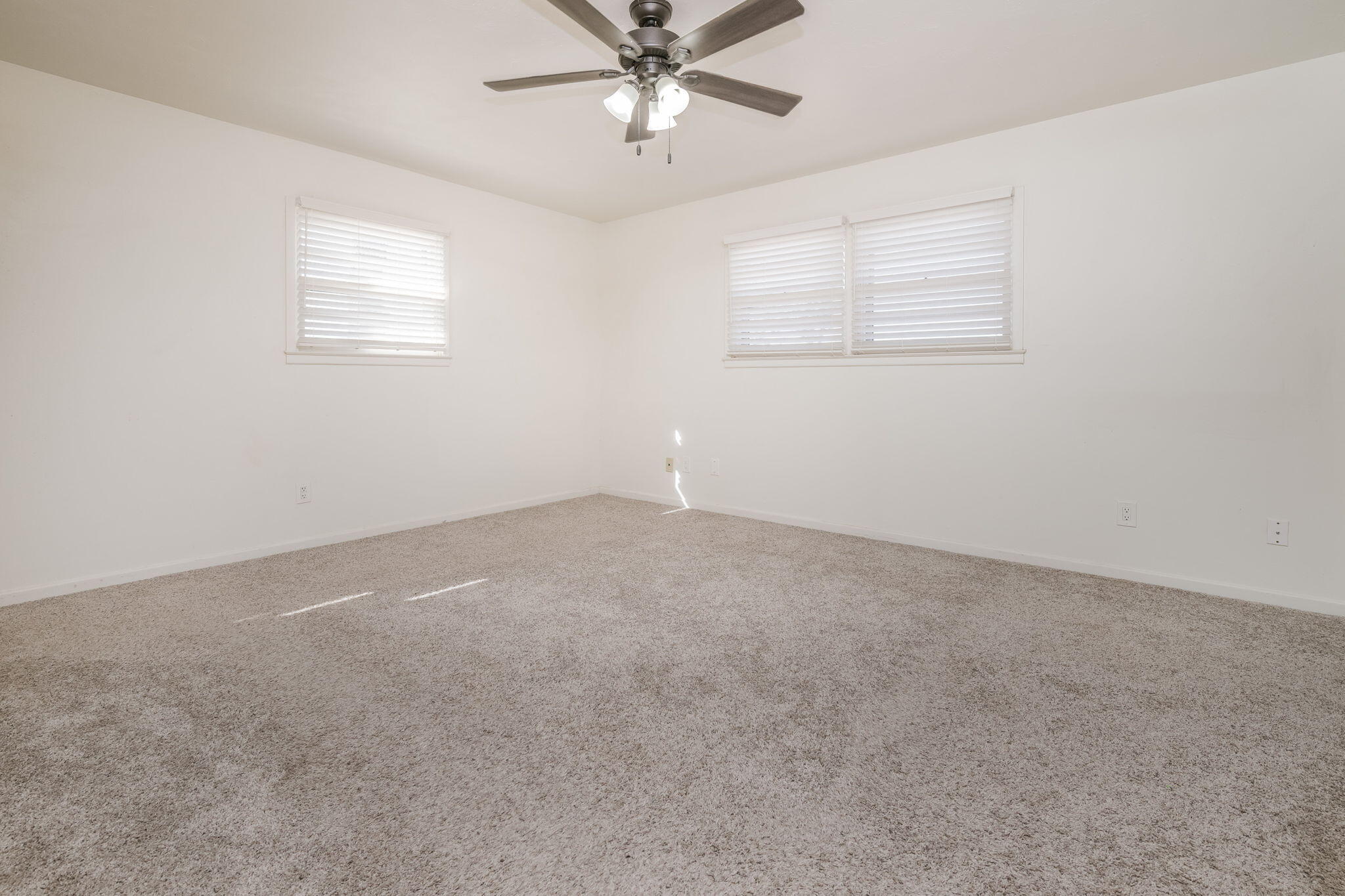 1723 County Road 9 Tulia, TX 79088 - Photo 17 of 32 an empty room with a window and a fan