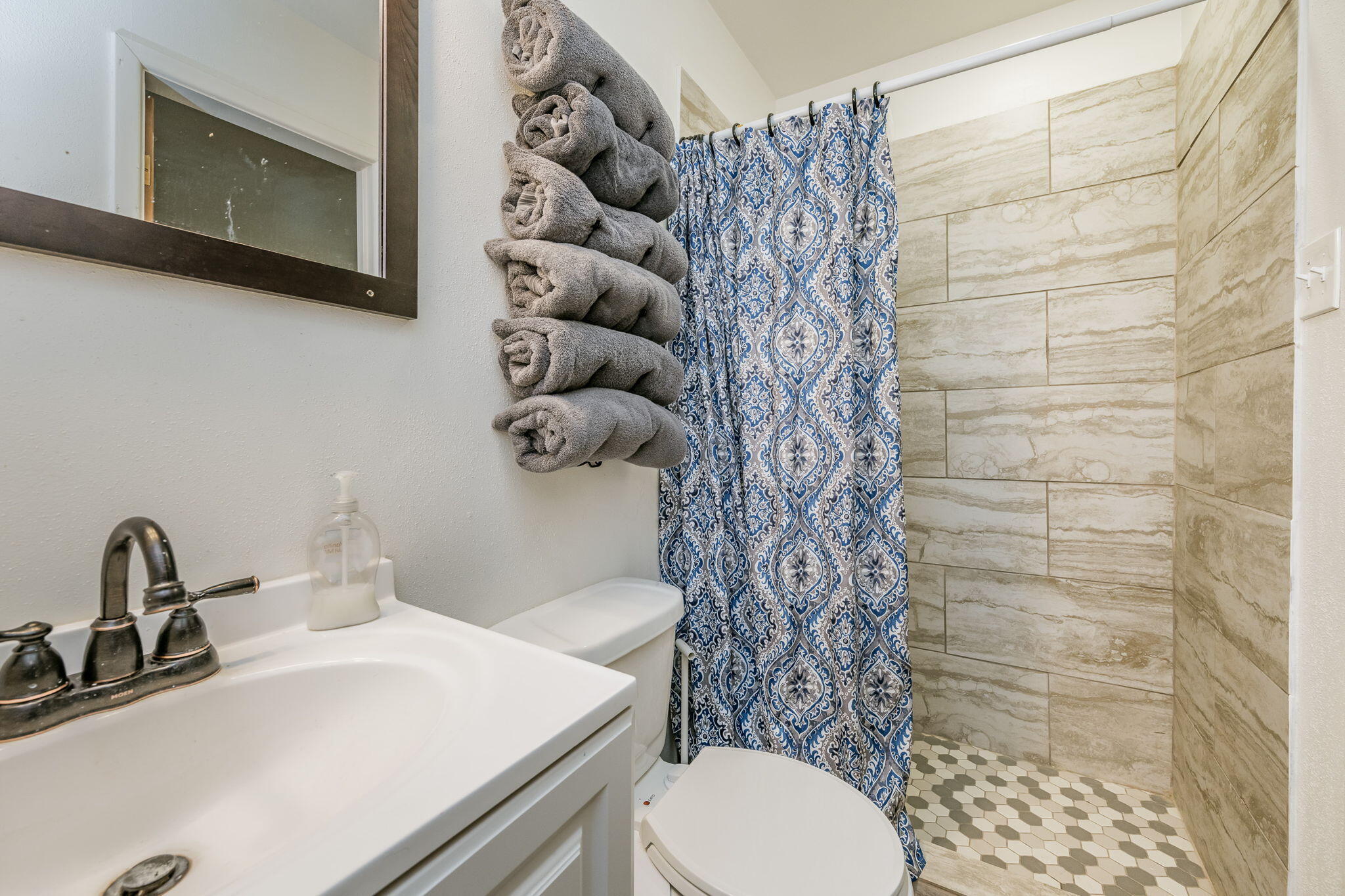 1723 County Road 9 Tulia, TX 79088 - Photo 20 of 32 a bathroom with a sink a toilet and shower curtain