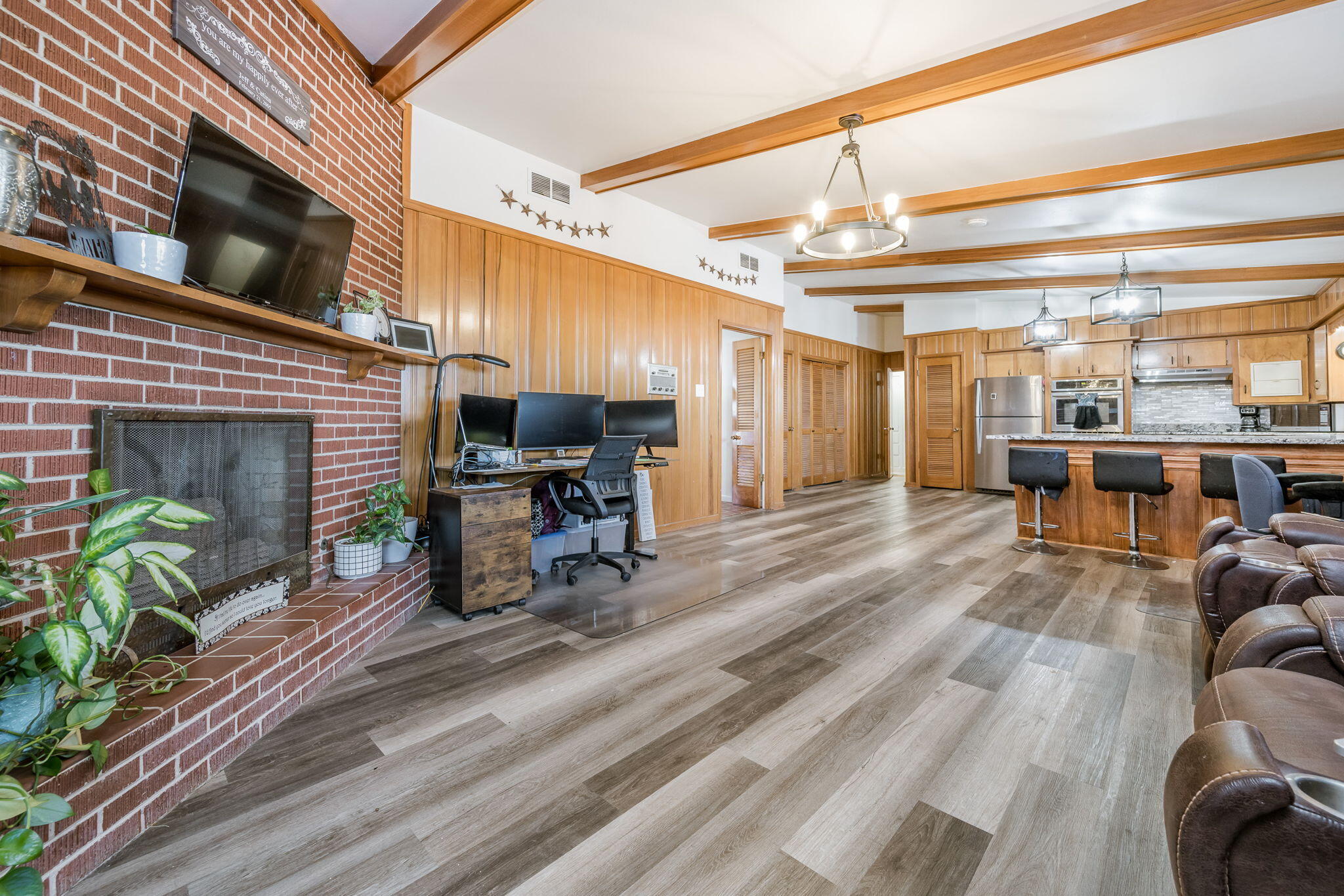 1723 County Road 9 Tulia, TX 79088 - Photo 8 of 32 a living room with furniture a fireplace and a table