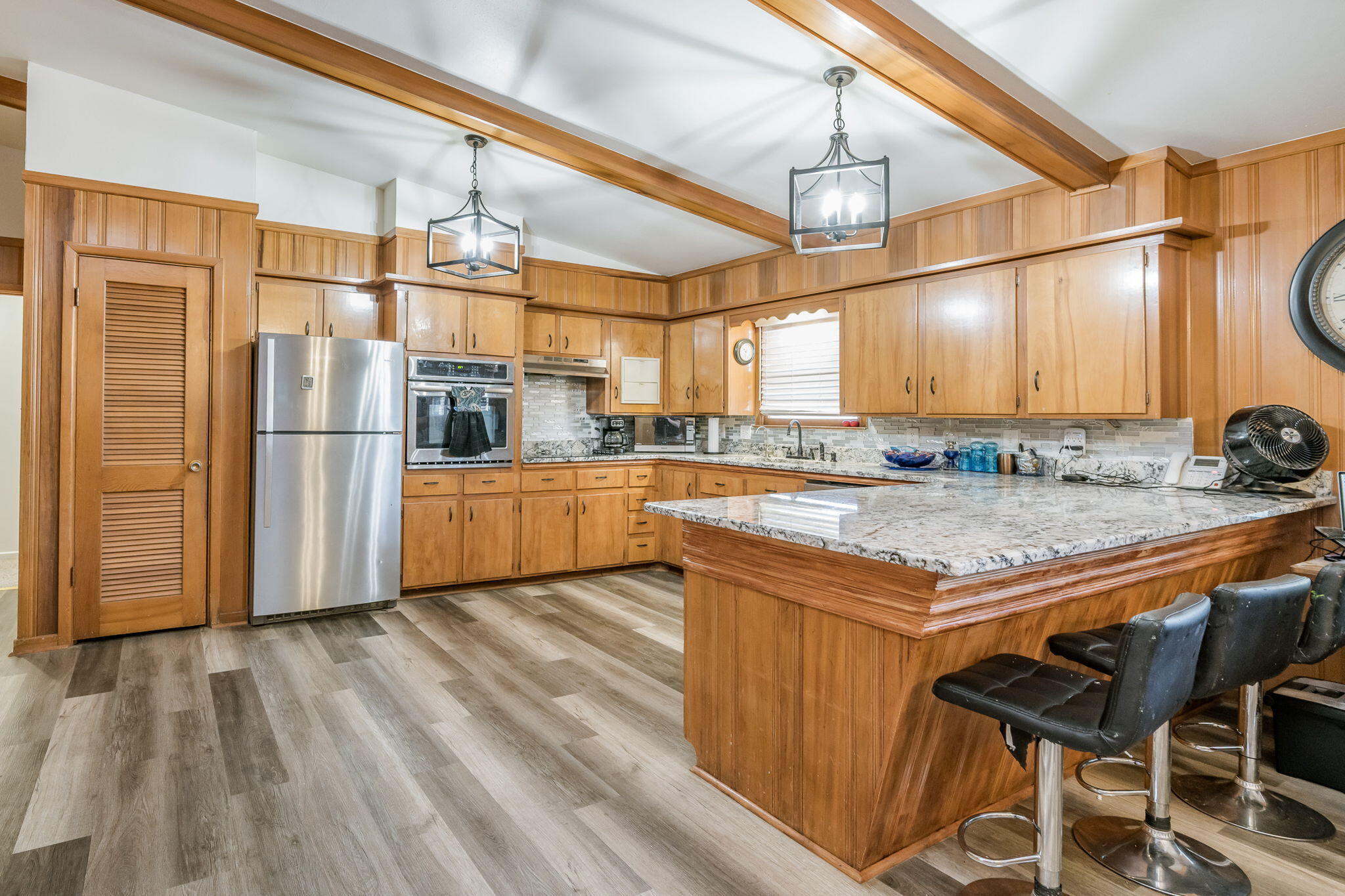 1723 County Road 9 Tulia, TX 79088 - Photo 9 of 32 a kitchen with stainless steel appliances granite countertop a sink and a refrigerator