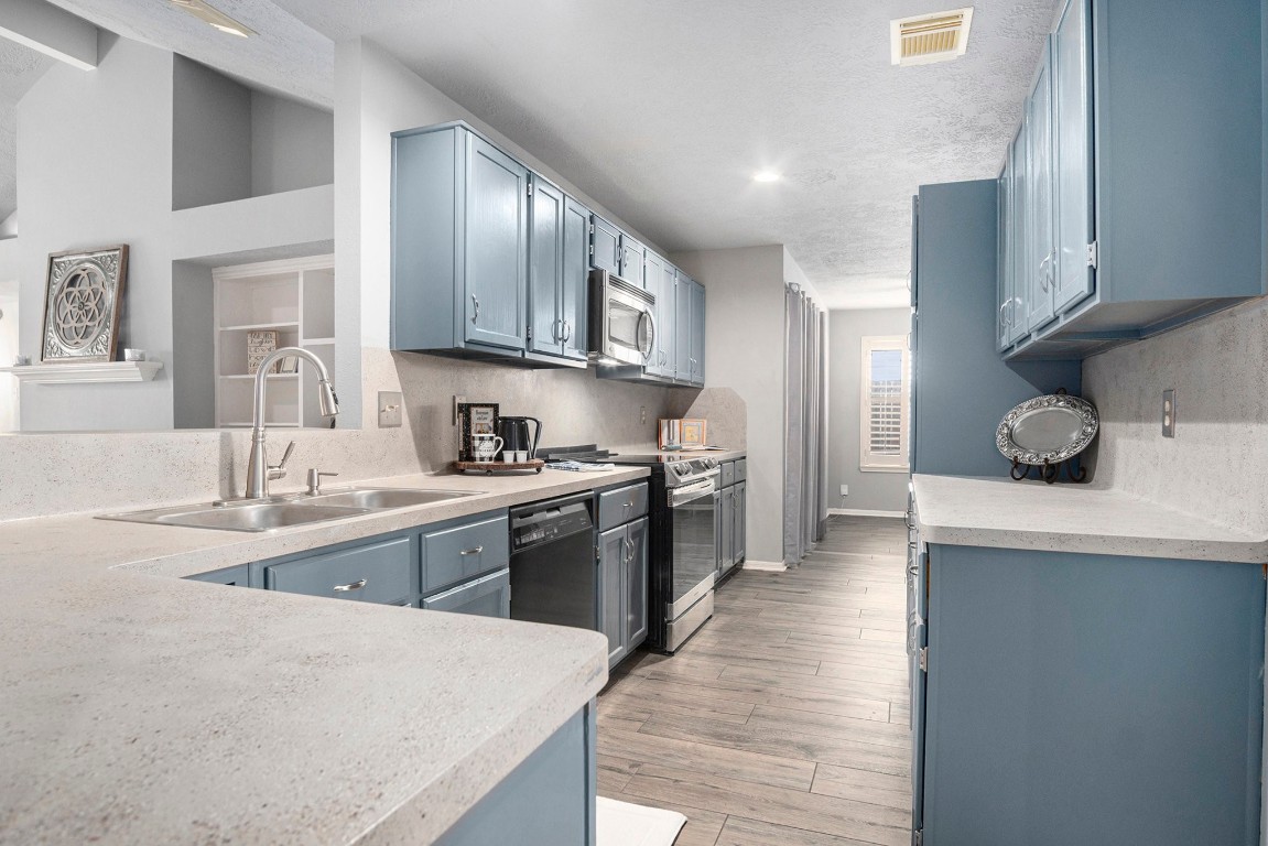 3315 Mourning Dove Drive Spring, TX 77388 - Photo 13 of 44 a large kitchen with stainless steel appliances lots of counter space and a sink