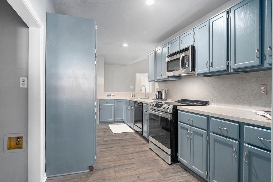 3315 Mourning Dove Drive Spring, TX 77388 - Photo 14 of 44 a kitchen with stainless steel appliances granite countertop a stove a sink and a microwave