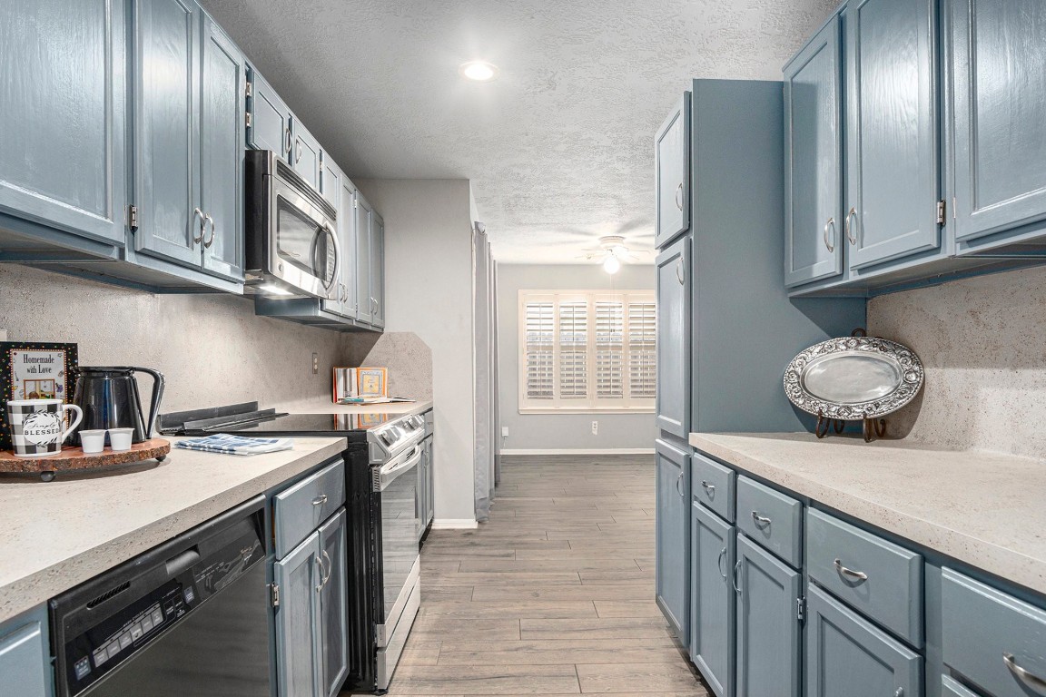 3315 Mourning Dove Drive Spring, TX 77388 - Photo 17 of 44 a kitchen with stainless steel appliances granite countertop a stove a sink and a refrigerator