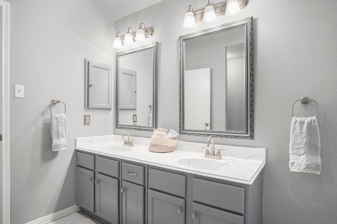 3315 Mourning Dove Drive Spring, TX 77388 - Photo 31 of 44 a bathroom with 2 sink and a mirror