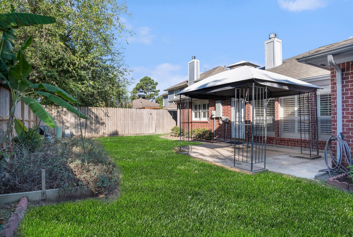 3315 Mourning Dove Drive Spring, TX 77388 - Photo 39 of 44 a view of a patio with a table and chairs under an umbrella