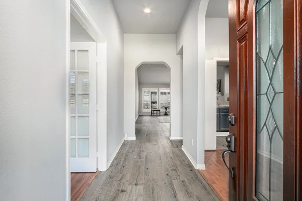 a view of hallway with wooden floor