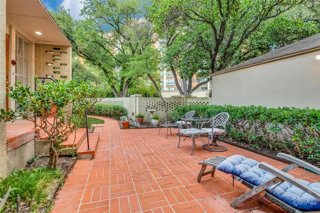 a swimming pool with outdoor seating and plants