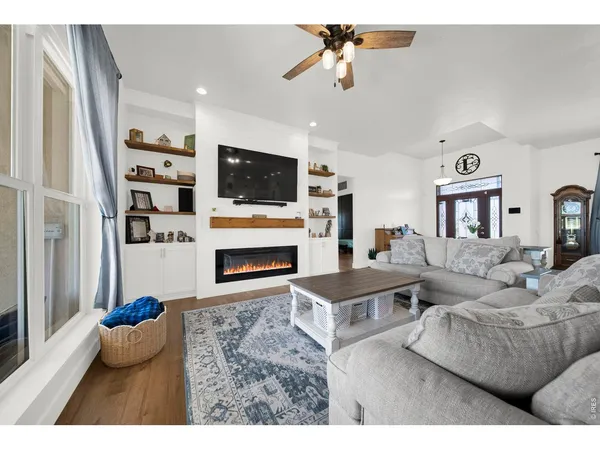 a living room with furniture a flat screen tv and a fireplace