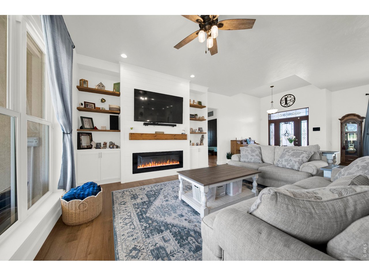 20138 State Highway 52, Unit 5 Fort Morgan, CO 80701 - Photo 12 of 50 a living room with furniture a flat screen tv and a fireplace