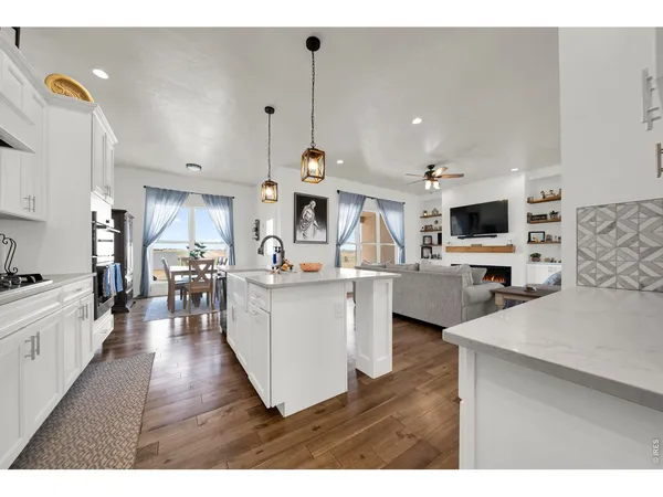 a open kitchen with white cabinets and stainless steel appliances