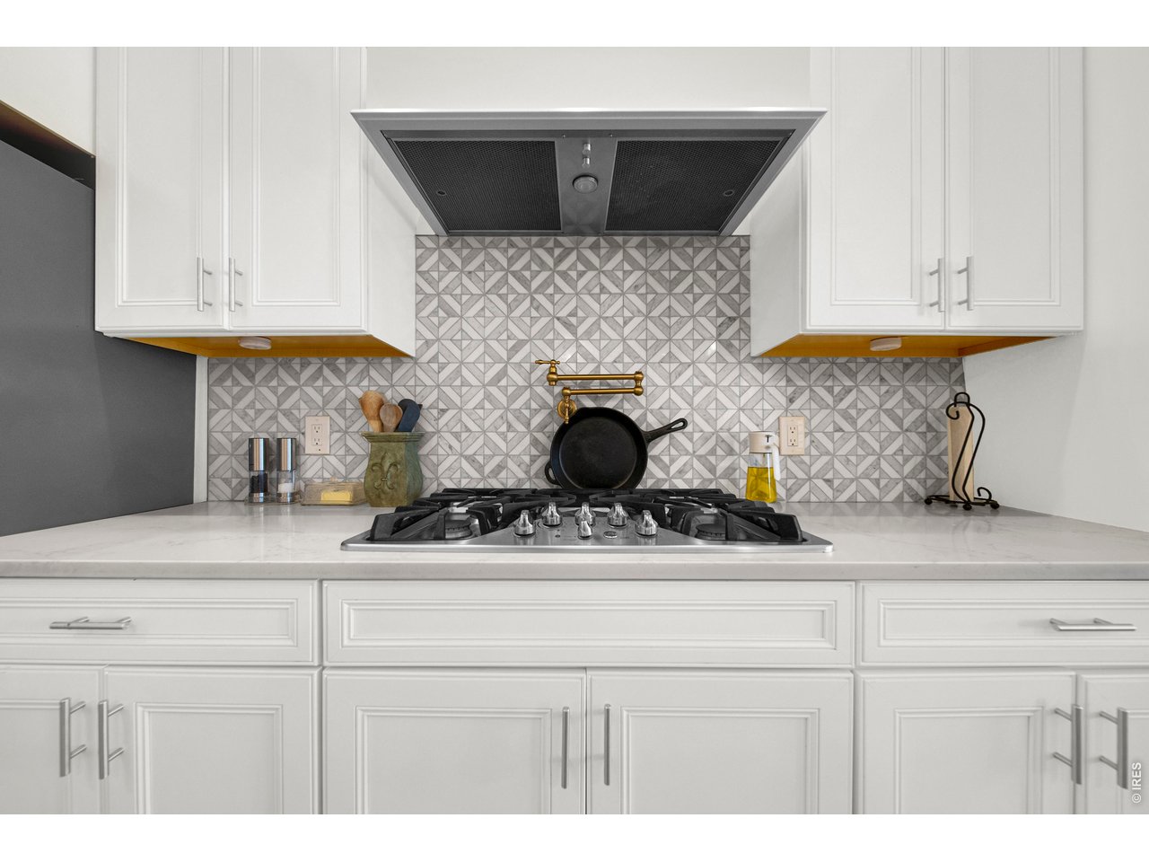 20138 State Highway 52, Unit 5 Fort Morgan, CO 80701 - Photo 15 of 50 a kitchen with white cabinets and a stove