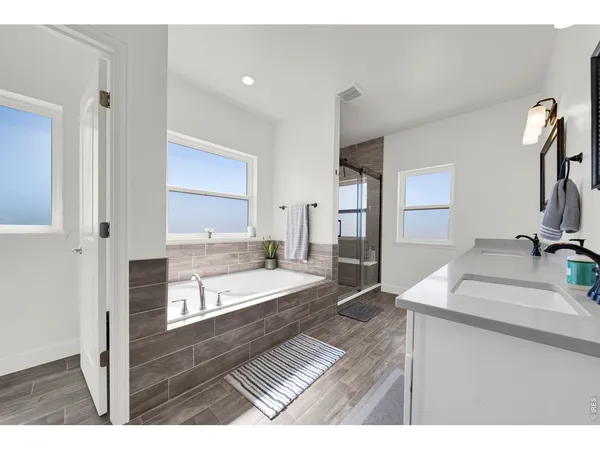 a bathroom with a bathtub and a shower