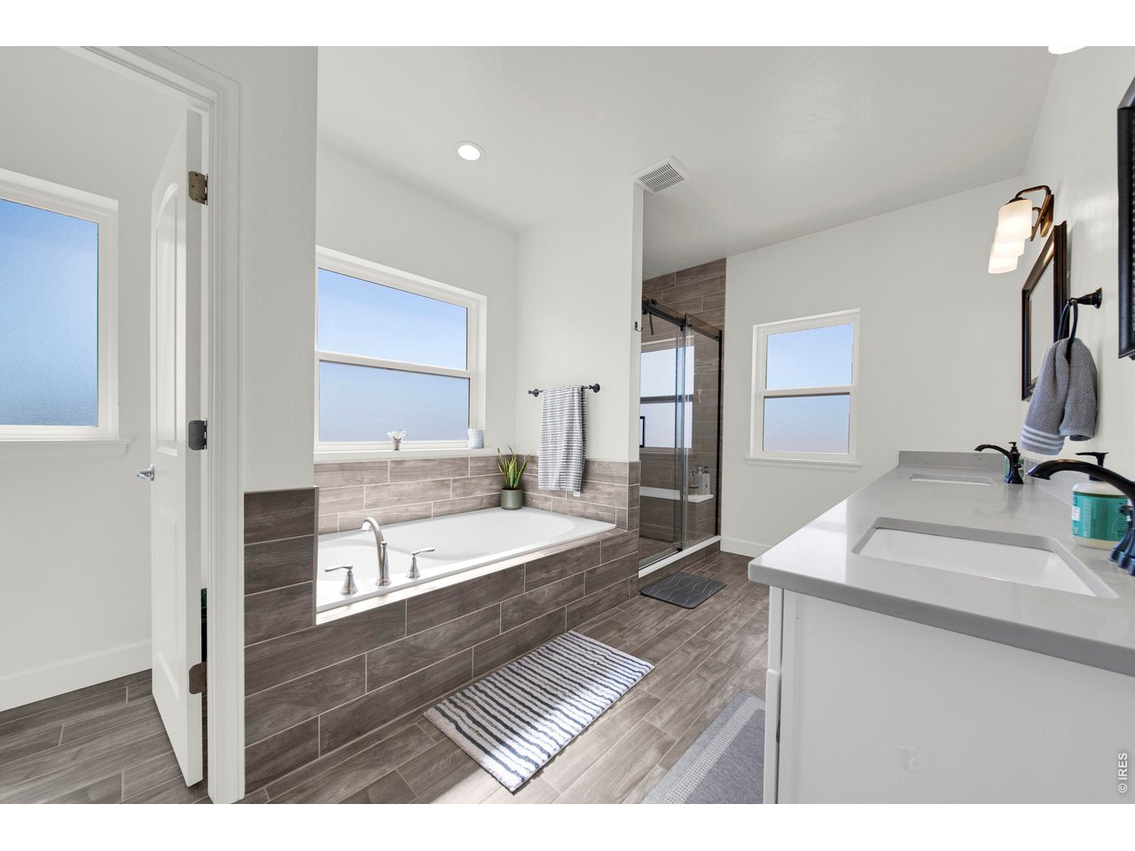 20138 State Highway 52, Unit 5 Fort Morgan, CO 80701 - Photo 22 of 50 a en suite bathroom with a granite countertop sink and a large mirror