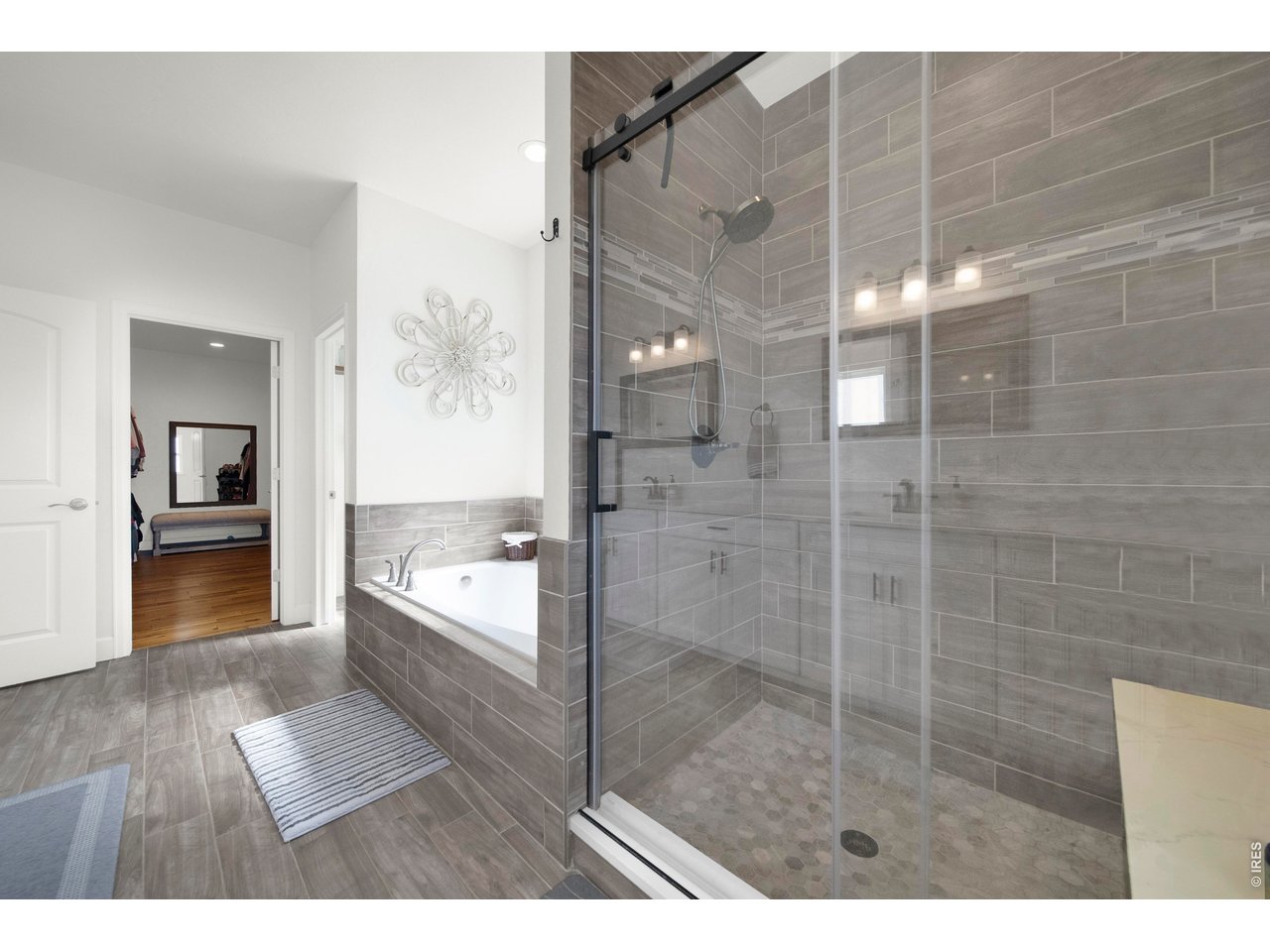 20138 State Highway 52, Unit 5 Fort Morgan, CO 80701 - Photo 23 of 50 a bathroom with a glass shower door and a bathtub