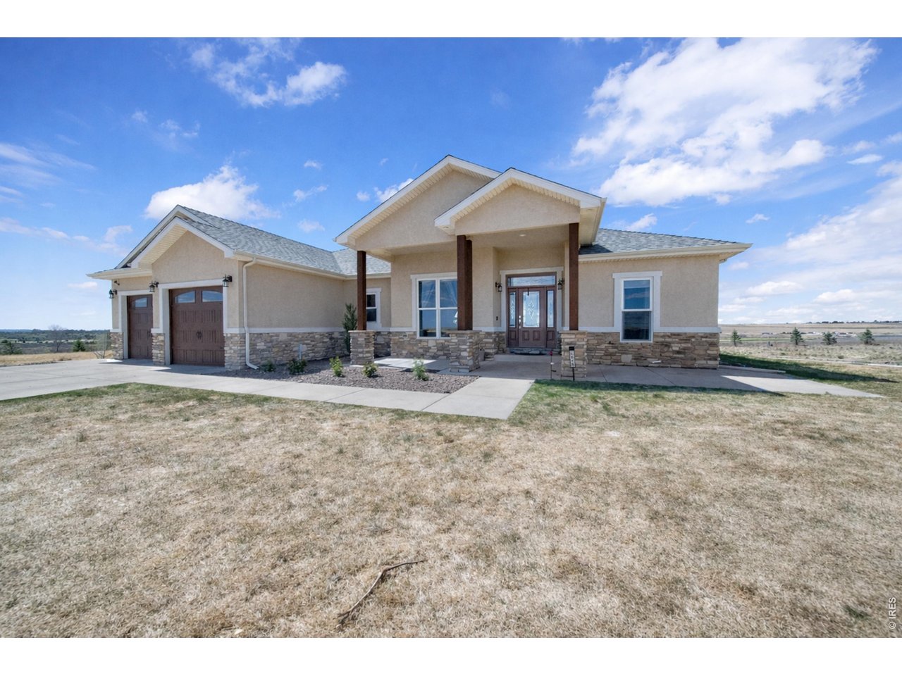 20138 State Highway 52, Unit 5 Fort Morgan, CO 80701 - Photo 3 of 50 a front view of a house with a yard