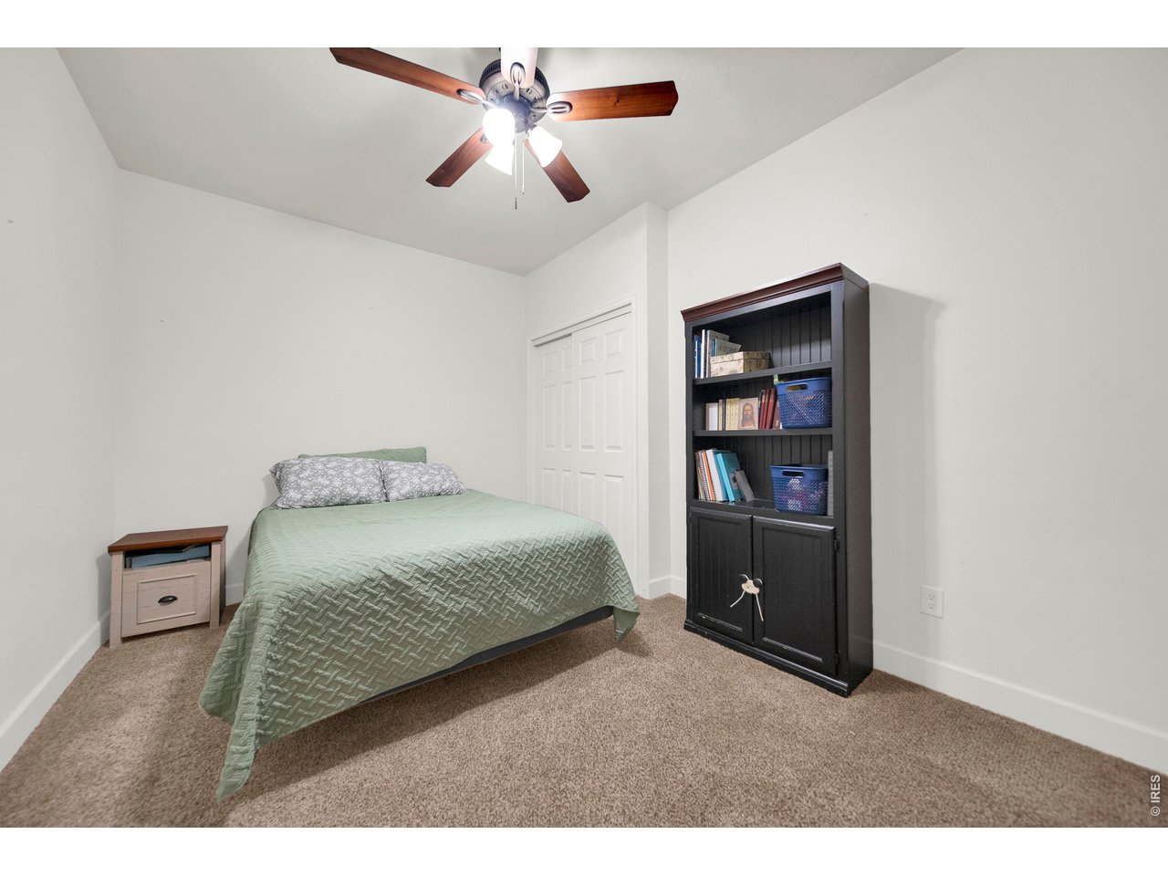 20138 State Highway 52, Unit 5 Fort Morgan, CO 80701 - Photo 36 of 50 a bedroom with a bed and a book shelf
