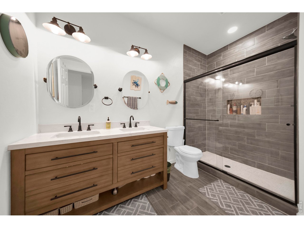 20138 State Highway 52, Unit 5 Fort Morgan, CO 80701 - Photo 37 of 50 a bathroom with a double vanity sink toilet mirror and shower