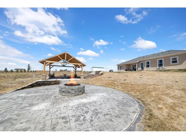 a view of a house with backyard and sitting area