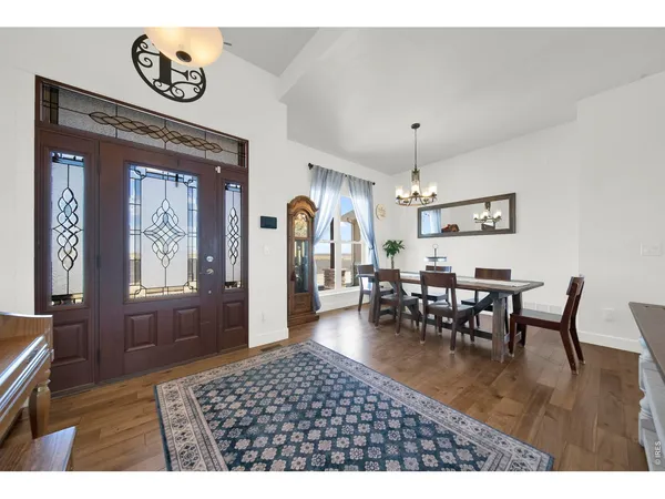 a dining room with furniture window and wooden floor