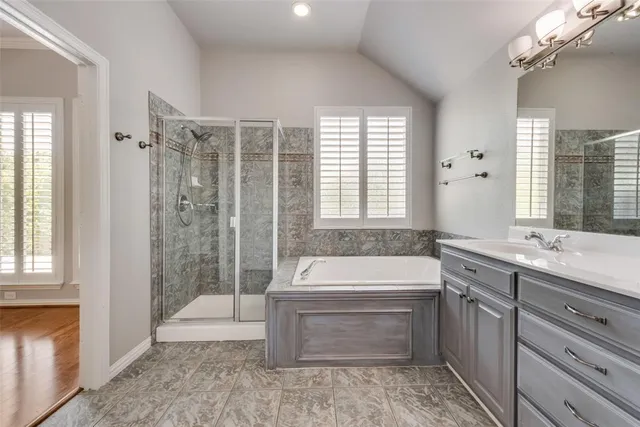 a bathroom with a tub sink and mirror