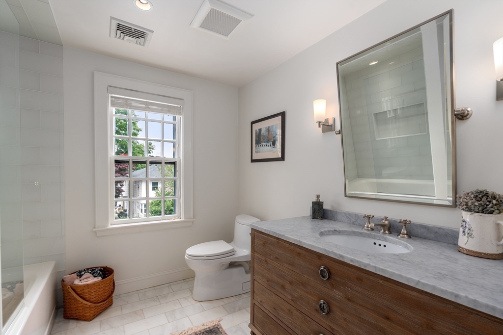 125 Rutledge Road Belmont, MA 02478 - Photo 24 of 40 a bathroom with a granite countertop sink mirror and a toilet
