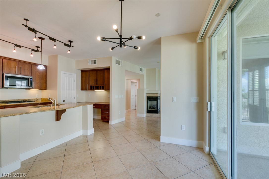 2555 Hampton Road, Unit 3203 Henderson, NV 89052 - Photo 23 of 43 Tile flooring and sliding glass doors enhance this open, versatile living space.