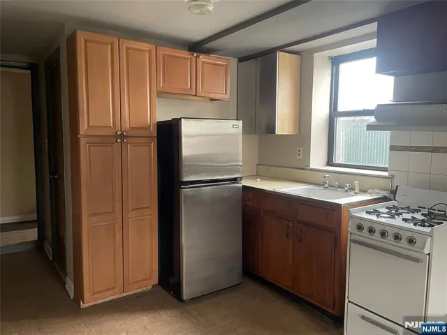 a kitchen with a refrigerator stove and sink