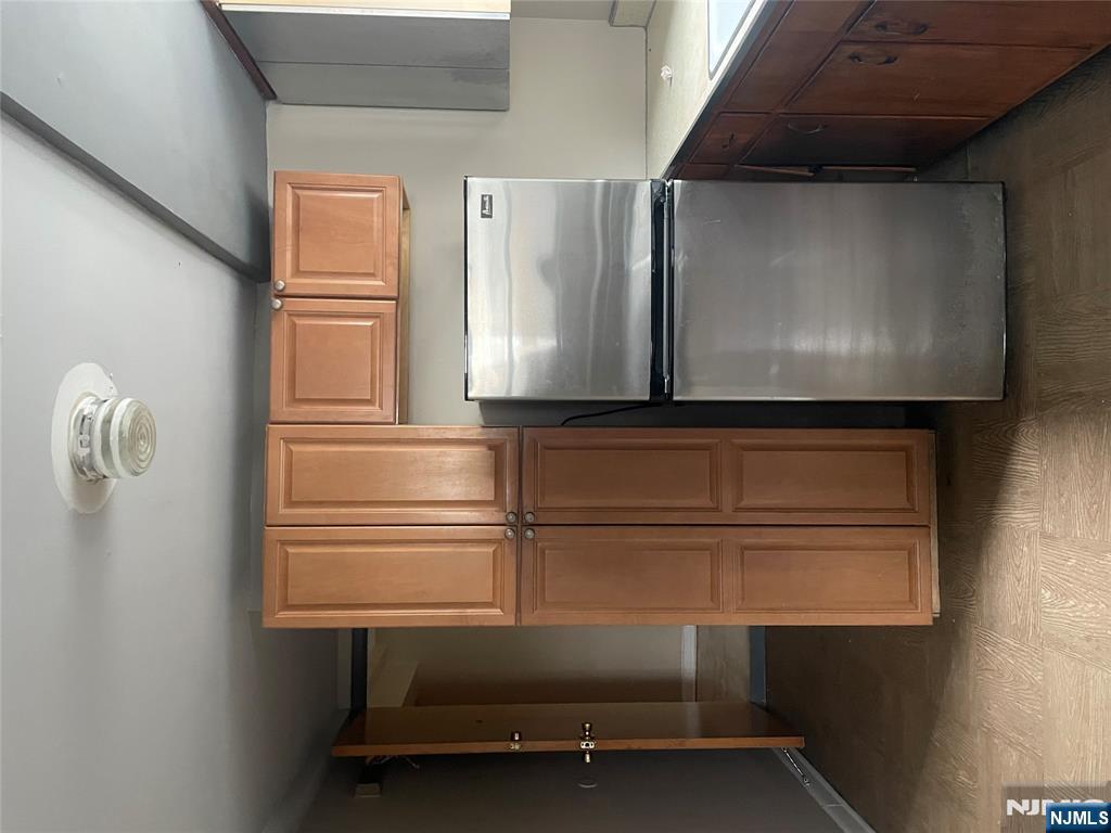 232-230 Anderson Avenue, Unit 1A Fairview, NJ 07022 - Photo 6 of 8 a kitchen with stainless steel appliances granite countertop a refrigerator and a sink