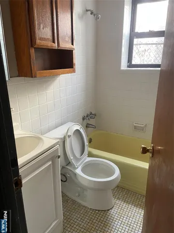 a bathroom with a toilet a sink and a window